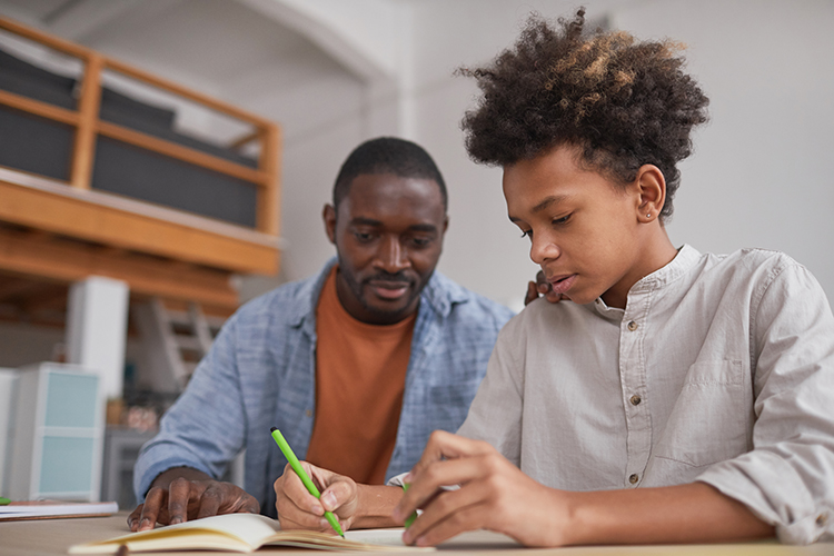 african-american-boy-doing-homework-with-dad-2021-09-24-04-16-06-utc