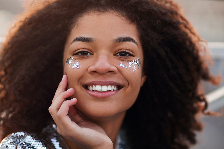 party-girl-overjoyed-charming-african-american-woman-curly-hair-glitter-cheekbone-smiling-happily_t20_XNBz2z